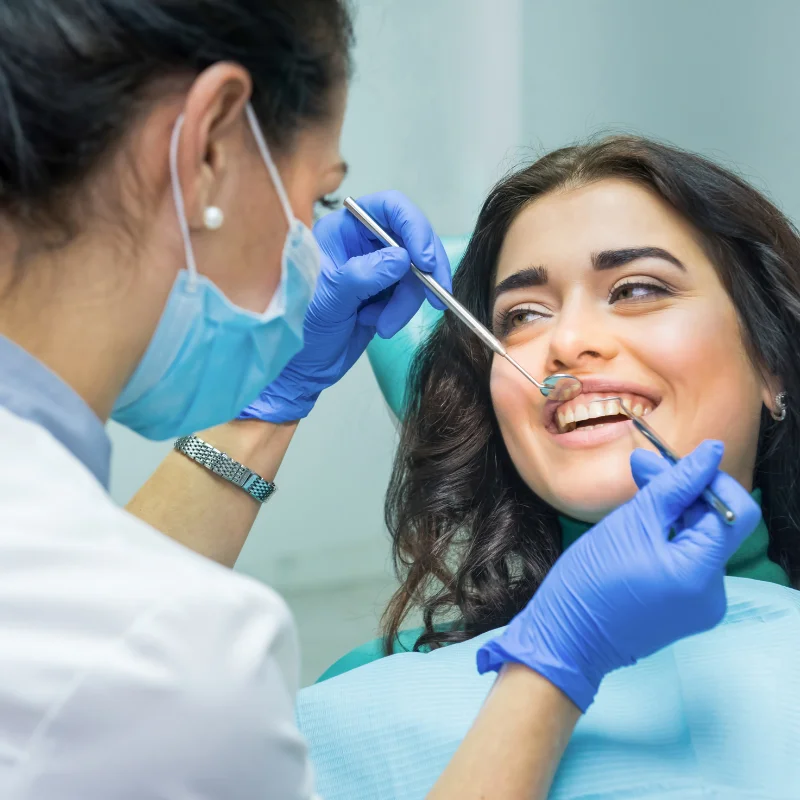 Dentist examining a patient’s teeth during a dental implant consultation at Riverfront Dental in Cambridge Ontario