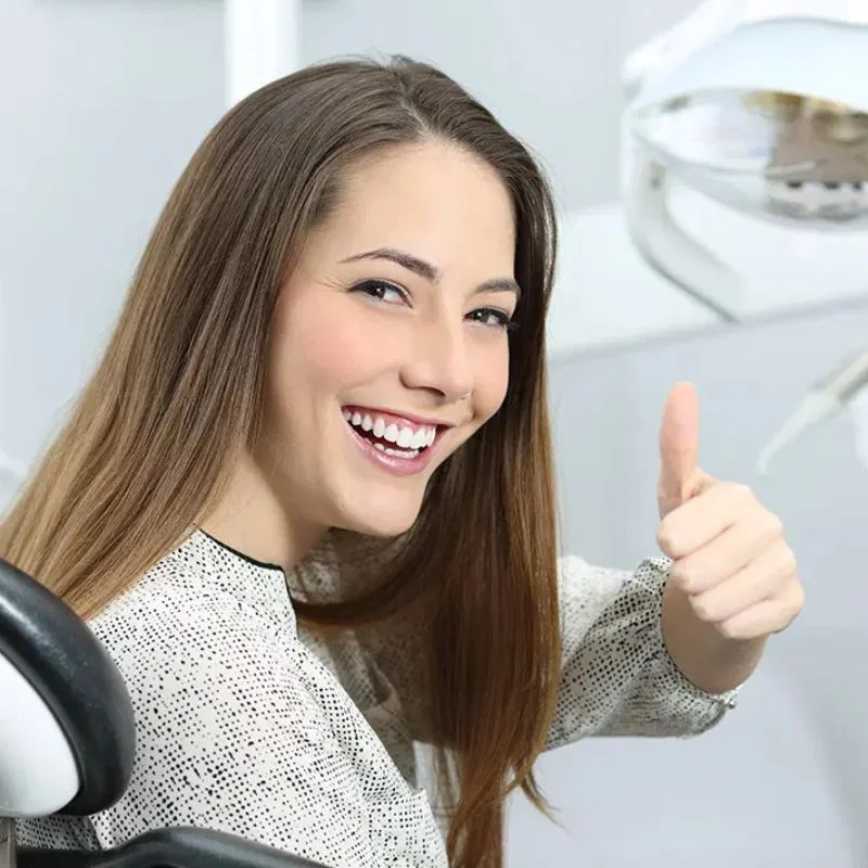 Smiling patient giving a thumbs up after successful dental implant treatment at Riverfront Dental in Cambridge Ontario