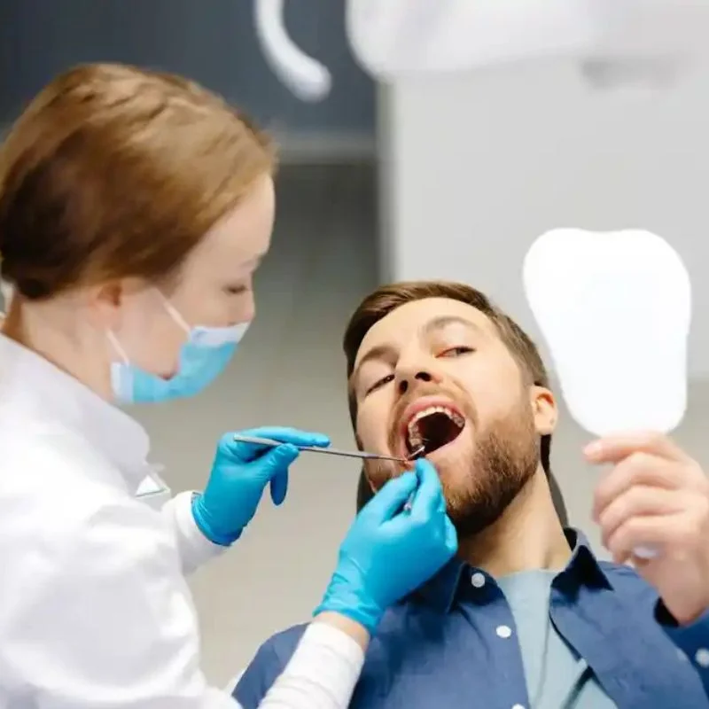 Patient checking smile after dental crown treatment at Riverfront Dental in Cambridge Ontario