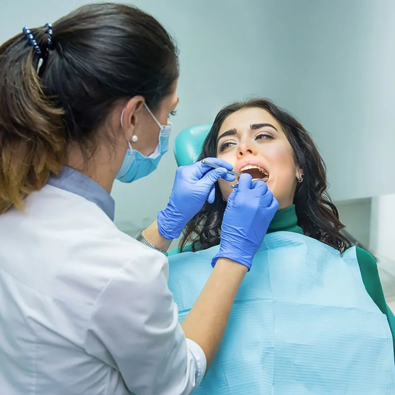 Dentist examining a patient’s teeth during an emergency dental treatment at Riverfront Dental in Cambridge Ontario