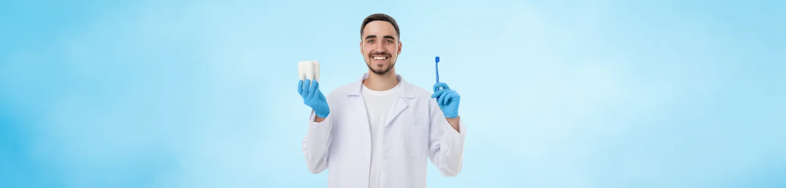 Dentist holding tooth model representing dental crown treatment at Riverfront Dental in Cambridge ON