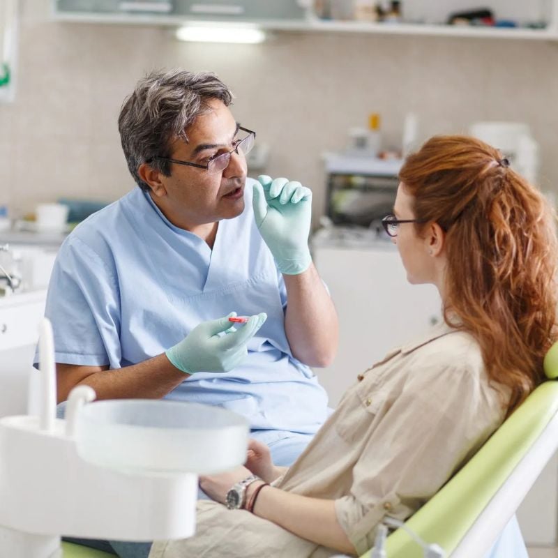 Dentist explaining a root canal treatment to a patient during a consultation at Riverfront Dental in Cambridge Ontario
